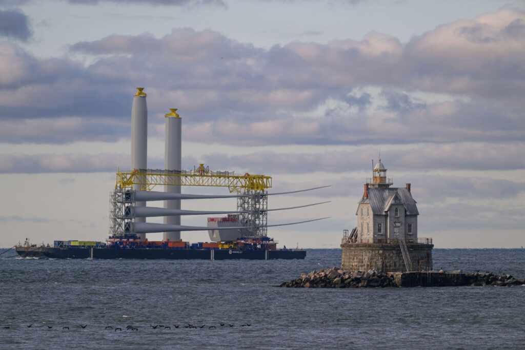 Juxtaposing more than four generations of engineering -
witnessed the morning of November 23 when the first of the Ørsted Wind Farm towers traveled from New London. 
Photo Credit: Todd McCormack